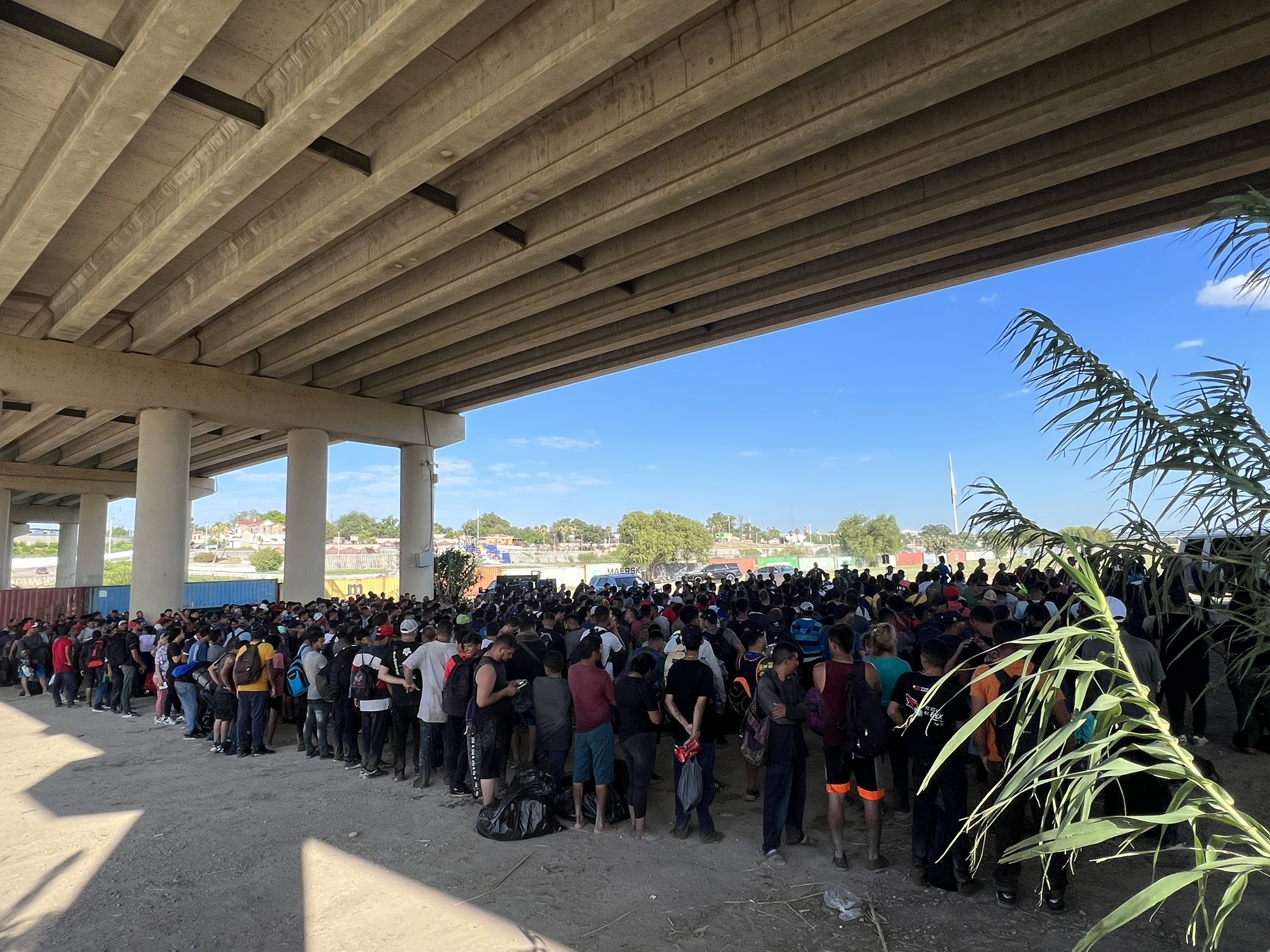 Illegal migrants waiting under an overpass.