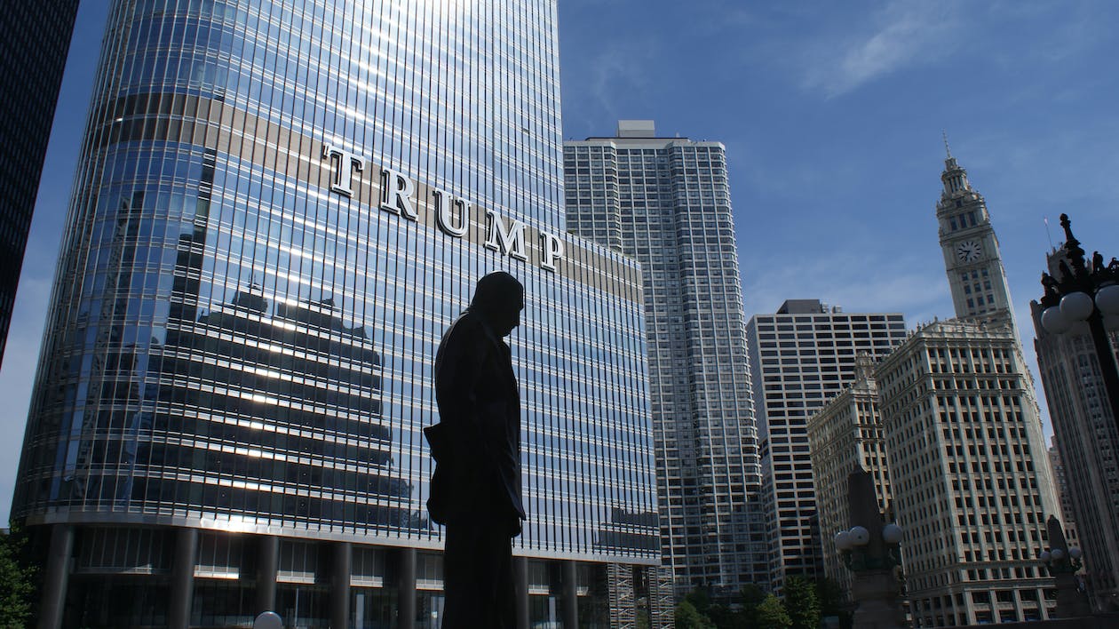 Silhouette of Statue Near Trump Building at Daytime.