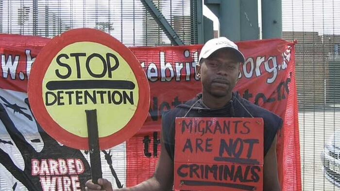 NextImg:Illegal UK Immigrant Who Protested With Sign Saying "Migrants Are Not Criminals" Pleads Guilty To Rape Of 15-Year-Old Girl