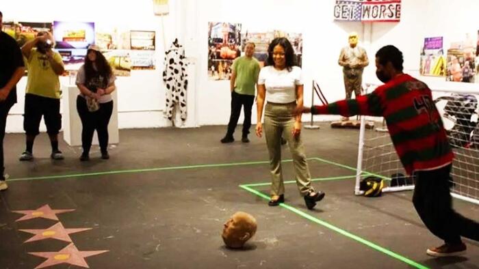 NextImg:'Anti-Hate' Art Exhibit In LA Featured Participants Kicking Around Donald Trump's Head