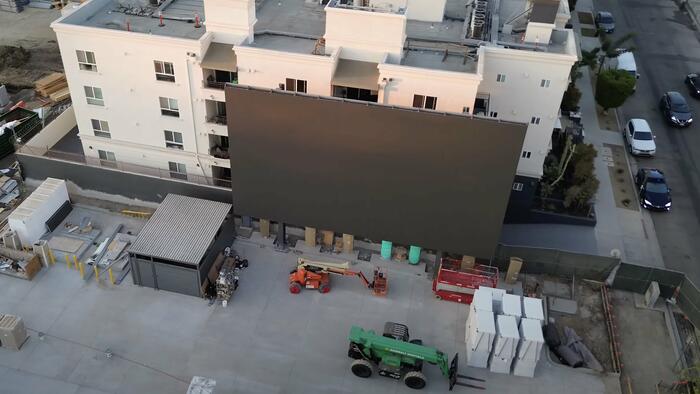 NextImg:Elon Musk's 1950s-Style Drive-In Supercharger Installs Giant 45-Foot LED TV Screen