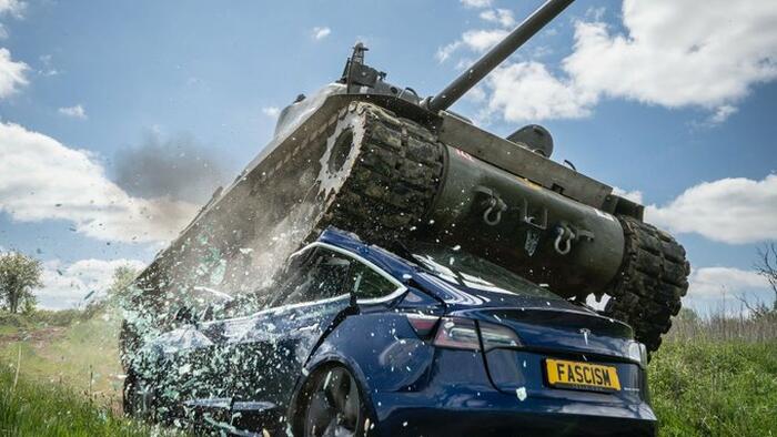 NextImg:Watch: Anti-Musk Activists Crush Tesla With Tank In Politically-Motivated Stunt