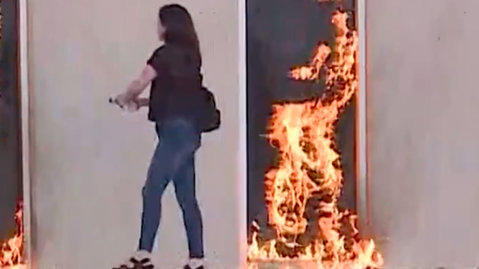 Watch: Unhinged Woman Tries To Burn Down Rumored ICE Building