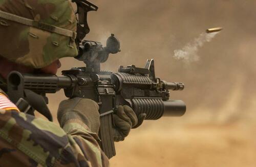 A soldier firing a rifle. 