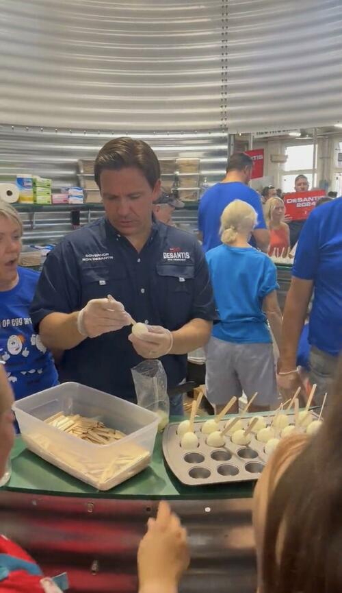 DeSantis putting hard boiled eggs on popsicle sticks at the Iowa State Fair.