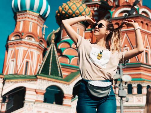 A woman dancing in front of St. Basil's Cathedral in Moscow.