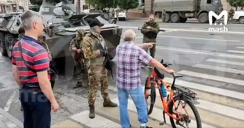 A Russian civilian speaks with Wagner Group soldiers in Rostov.