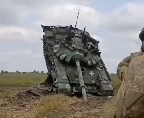 A Ukrainian T-64 stuck on top of another armored vehicle.