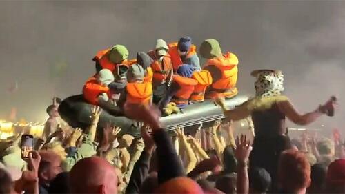 Banksy 'Launches’ Migrant Boat Stunt At Glastonbury Festival, Which Has An 8-Mile-Long, 20ft-High Border-Wall