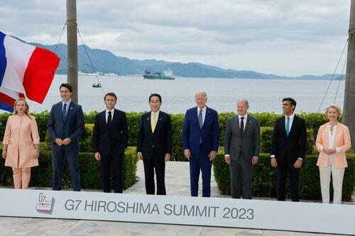 (L-R) Italy's Primer Minister Giorgia Meloni, Canada's Prime Minister Justin Trudeau, France's President Emmanuel Macron, Japan's Prime Minister Fumio Kishida, U.S. President Joe Biden, German Chancellor Olaf Scholz, Britain's Prime Minister Rishi Sunak, and European Commission President Ursula von der Leyen participate in a family photo with G7 leaders before their working lunch meeting on economic security at the Grand Prince Hotel in Hiroshima on May 20, 2023. (Jonathan Ernst/POOL/AFP via Getty Images)